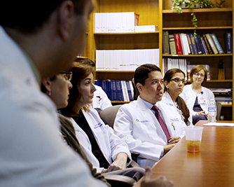 Dr. Vikas Majithia at a table with fellows.