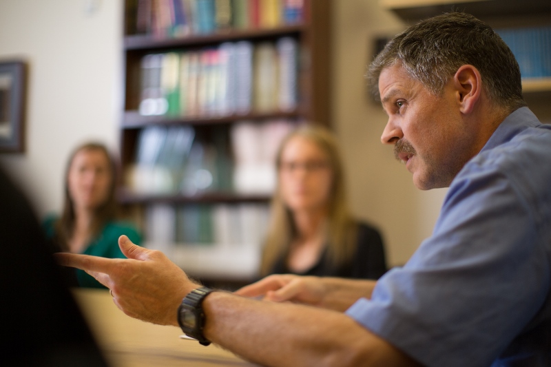 Associate Professor of Medicine at University of Colorado Dr. Deane in a meeting.