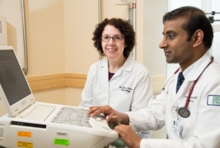 Rheumatology researchers at a computer.