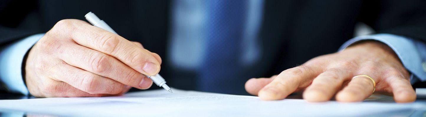 A man signing a contract.
