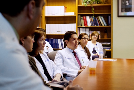 Rheumatology researchers gather around a table.