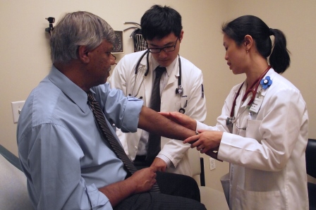 Dr. Karen Law and her colleague examine a patient with rheumatoid arthritis.